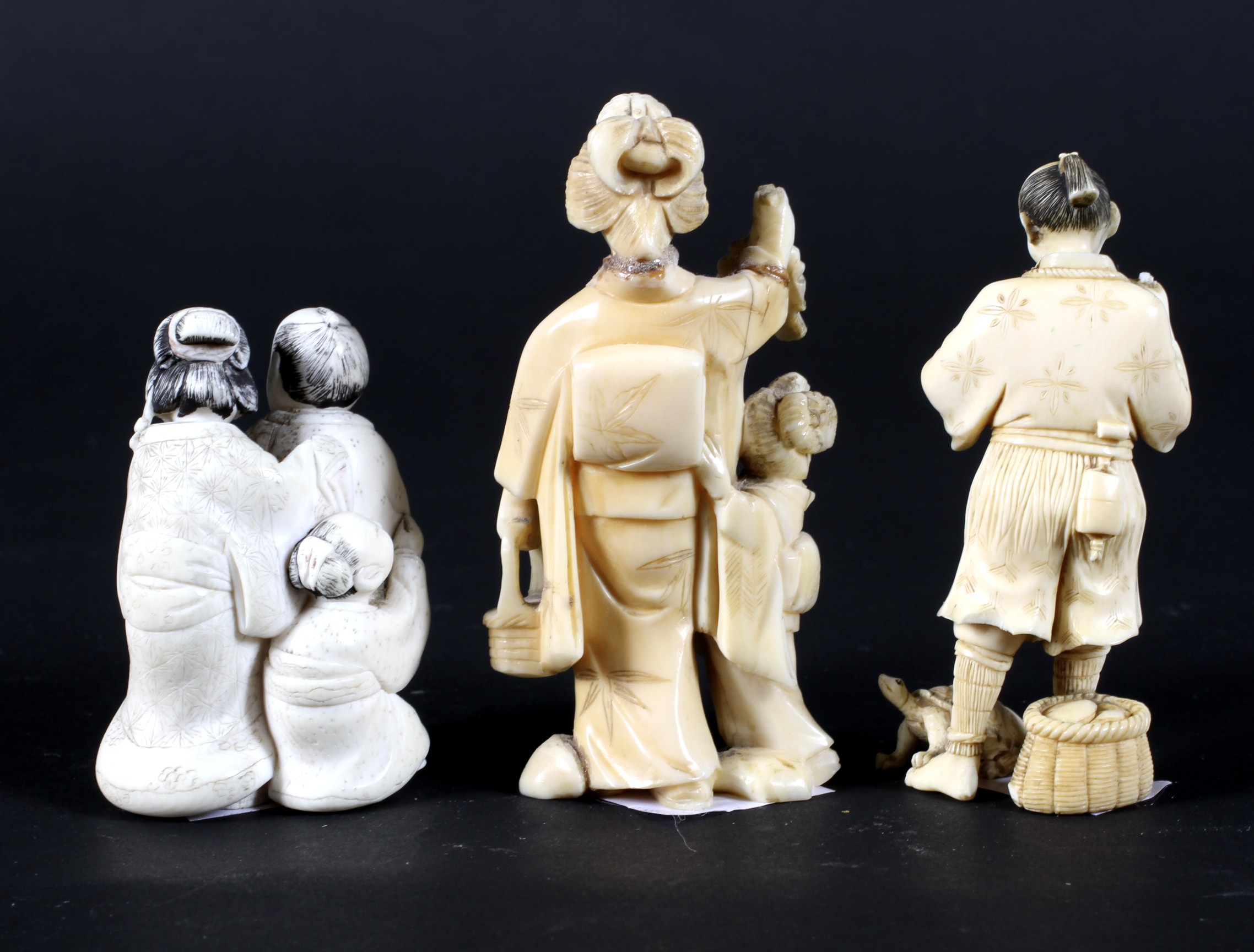 Three late 19th century Japanese carved ivory okimono, comprising a woman holding grapes, - Image 2 of 2