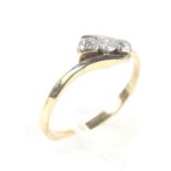 A gold (unmarked) three stone diamond ring with circular mounts, 2.