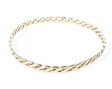 A 9ct gold bangle of intricate woven design,