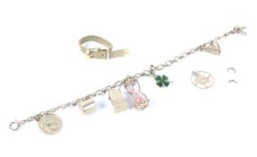 A 9ct gold charm bracelet with an assortment of eight charms, including a miniature dice,