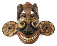 A large carved and painted wooden tribal wall mask, possibly Polynesian,