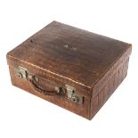 An early 20th century crocodile skin travelling toilet case,