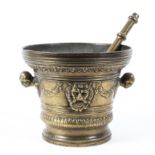 A large gilt-bronze Antique style pestle and mortar, cast with lion masks,