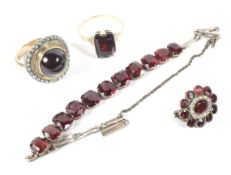 An assortment of 9ct and 14K gold and garnet set jewellery to include two rings,