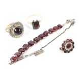 An assortment of 9ct and 14K gold and garnet set jewellery to include two rings,