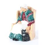 A Royal Doulton figure of an old lady sleeping in a chair, titled 'Forty Winks',