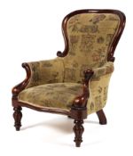 A Victorian mahogany framed spoonback gentleman's elbow chair,