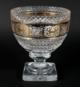 A large cut and gilt glass footed bowl, cut with diamonds, engraved with a band of flowers,