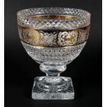 A large cut and gilt glass footed bowl, cut with diamonds, engraved with a band of flowers,