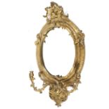 A mid-19th century giltwood and gesso oval girandole, with twin light leafy branches,