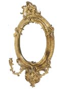 A mid-19th century giltwood and gesso oval girandole, with twin light leafy branches,