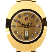 A gents Rado Diastar automatic day/date wristwatch, the gilt dial with stone set hour markers,