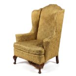 A Queen Anne style wing back upholstered armchair, early 20th century,