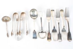 An assortment of siver spoons, tongs, forks and other items,