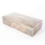 A cedar lined silver cigarette box, with engine turned decoration to the lid, monogramed GGC,