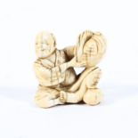 A late 19th century ivory netsuke of a seated man holding a sack on his knee, signed Senko (?),