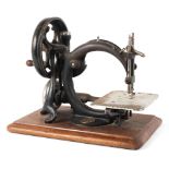 A 19th century Willcox & Gibbs sewing machine, mounted with gilt metal manuacturer's plaque,