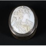 A 19th century oval silver snuff box inset with carved ivory portrait of a maiden, of oval form,