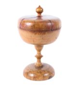 A 19th century sycamore treen footed pedestal bowl and cover, with knop finial,