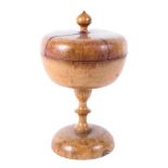 A 19th century sycamore treen footed pedestal bowl and cover, with knop finial,