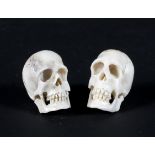 Two late 19th century carved ivory memento mori in the form of human skulls,