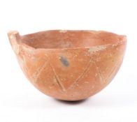 An early Bronze Age polished red earthenware bowl, incised with zig-zag ornament,