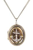 An ornate gold photo locket pendant, adorned with an anchor set with seed pearls,