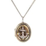 An ornate gold photo locket pendant, adorned with an anchor set with seed pearls,