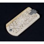 A late 19th century carved ivory retractable aide-memoire, carved with floral frettwork,