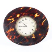 An Art Deco tortoiseshell mounted 8 day desk clock, of oval form,