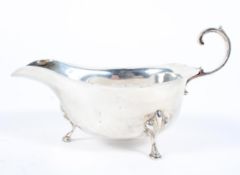 A silver sauceboat, with C scroll handle raised on the hoof feet, maker Adie Bros, Birmingham, 1937,