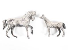 Two silver figures of a mare and her foal, maker S M D castings, London,