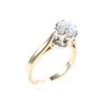 An 18ct diamond solitare ring, set in a raised claw mount with raised shoulders,