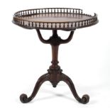A Georgian style mahogany galleried tripod table, with spindle gallery above tri-scroll support,