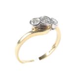 An 18ct gold three stone diamond ring, with twisted shoulders size O