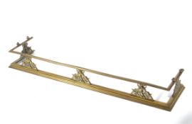 A decorative 19th century brass fender the upper rail supported by five pierced supports