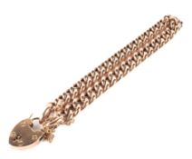 A 9ct rose gold curb link bracelet with heart locket,