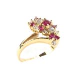 An 18ct yellow gold diamond and ruby dress ring, set in a twisted double shoulder setting, size I,