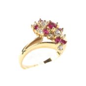 An 18ct yellow gold diamond and ruby dress ring, set in a twisted double shoulder setting, size I,