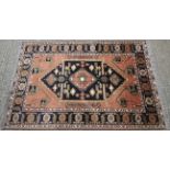 A 20th century Kazak wool carpet, woven with central blue,