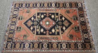 A 20th century Kazak wool carpet, woven with central blue,