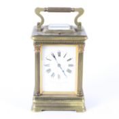 A Goldsmiths and Silversmiths Company brass striking carriage clock in leather case,
