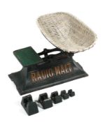 A set of vintage Radio-Malt advertising cast iron baby scales, with weights and wicker basket,