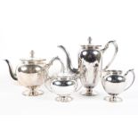 A Four piece silver tea set comprising a tea & coffee pot,