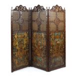 A late 19th century tooled leather and oak tri-parte screen/room divider,
