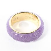 A 14ct gold ring, the exterior covered in heavily carved quartz,