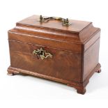 An early 20th Century mahogany three section tea caddy raised on sort shaped bracket feet,