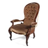 A Victorian button back mahogany framed armchair, with spoon-shaped back,