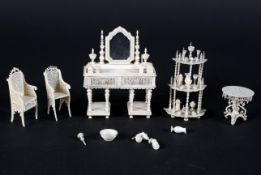 A collection of late 19th century carved ivory doll's house furniture, carved with frettwork,