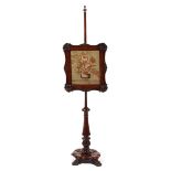 A Victorian carved mahogany pole screen with tapestry screen,